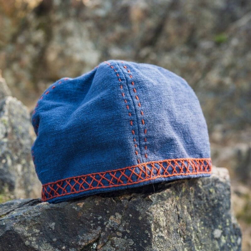 Blue Pirate cap showing red geometric crisscross embroidery