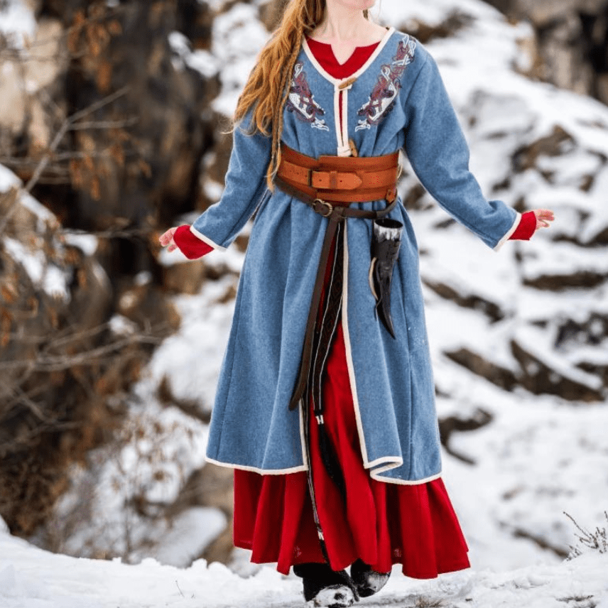 Woman in a blue Pirate coat worn open over a shirt