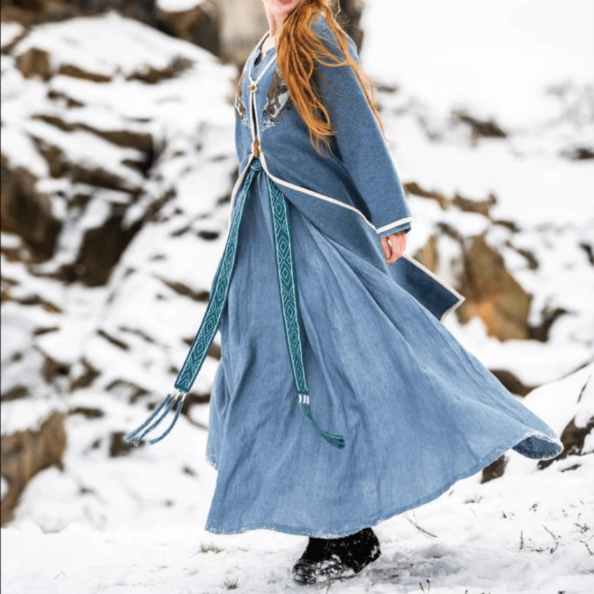Detail of the collar and embroidered trim on a blue coat