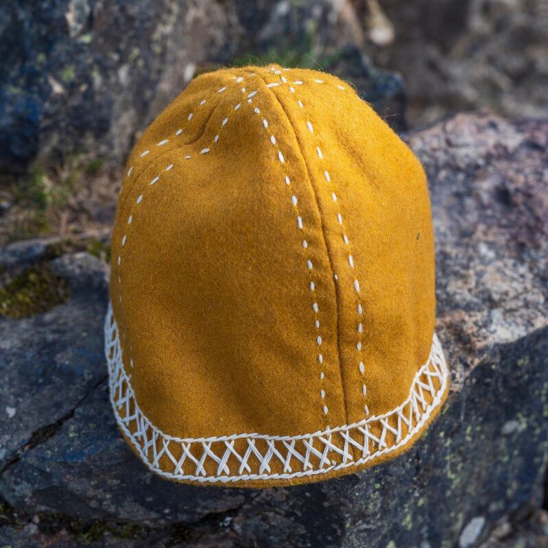 Mustard yellow conical wool cap with white geometric embroidery and latticed band, second view