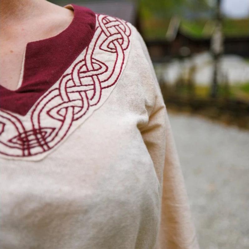 Red trim detail on a natural Pirate ladies dress