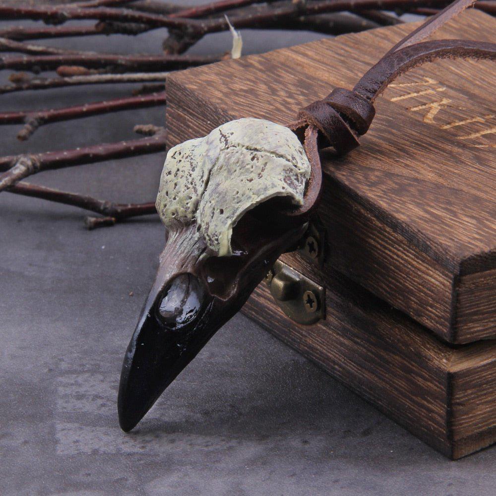 Front view of painted raven skull pendant