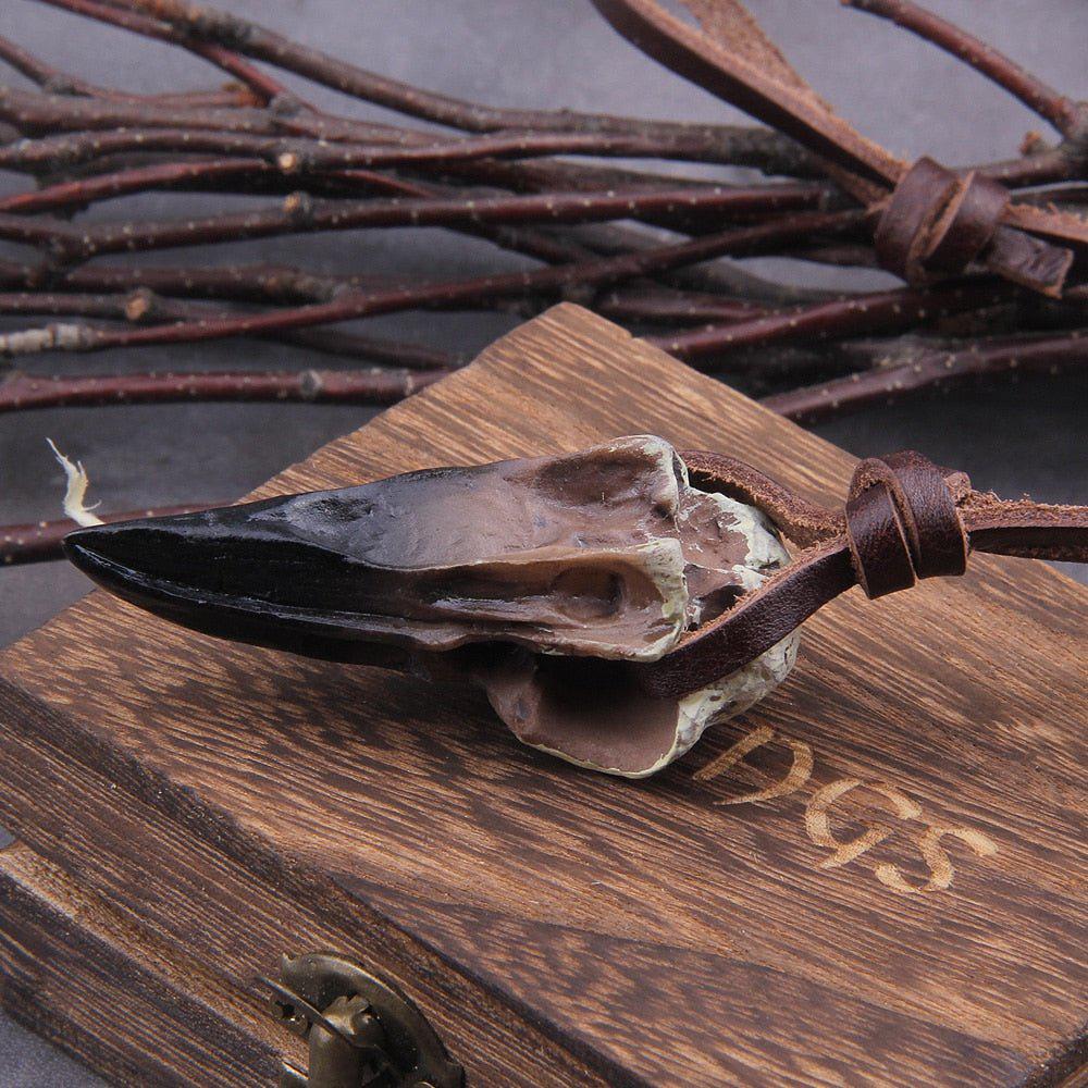 Side view of raven skull pendant showing beak profile