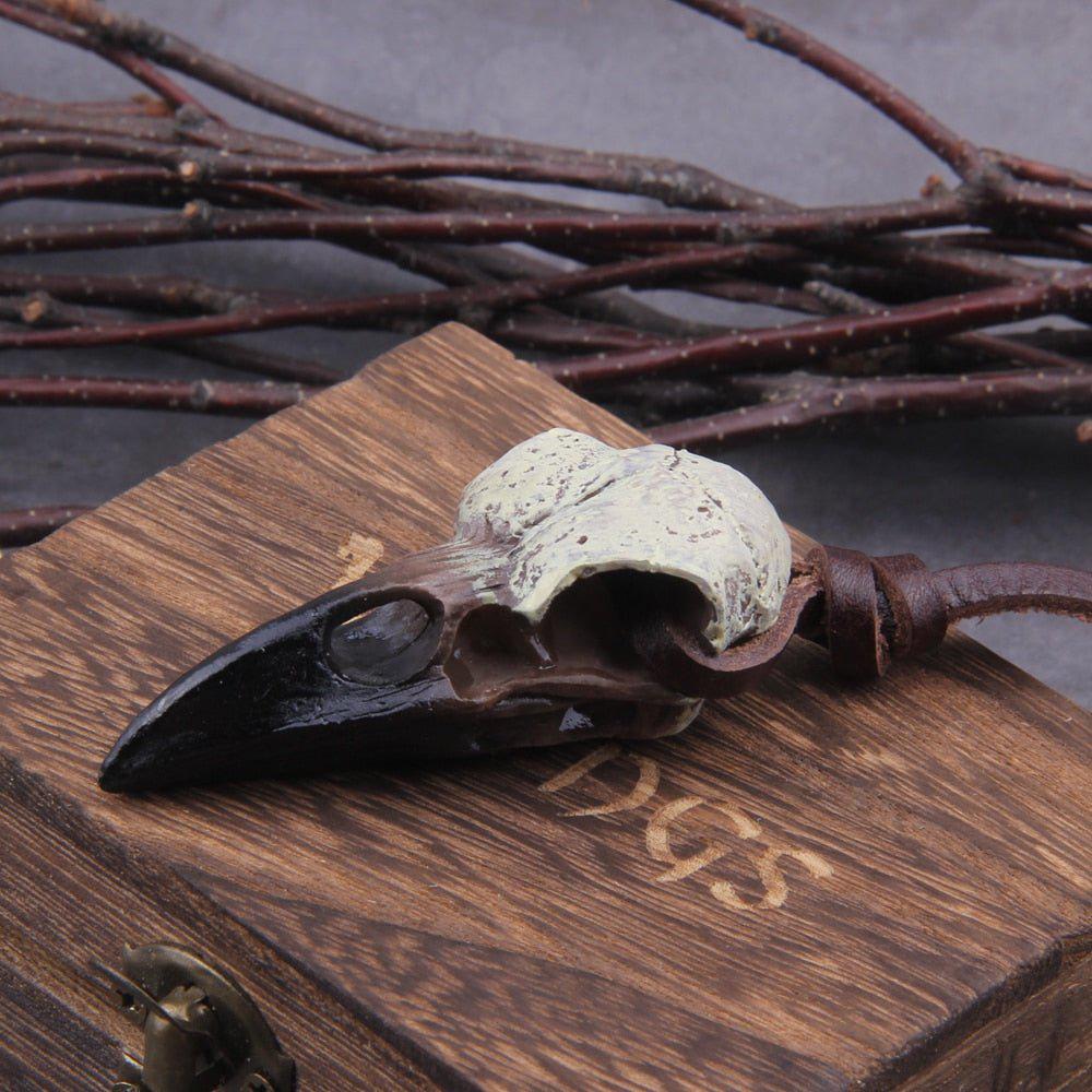 Raven skull pendant attached to brown leather cord
