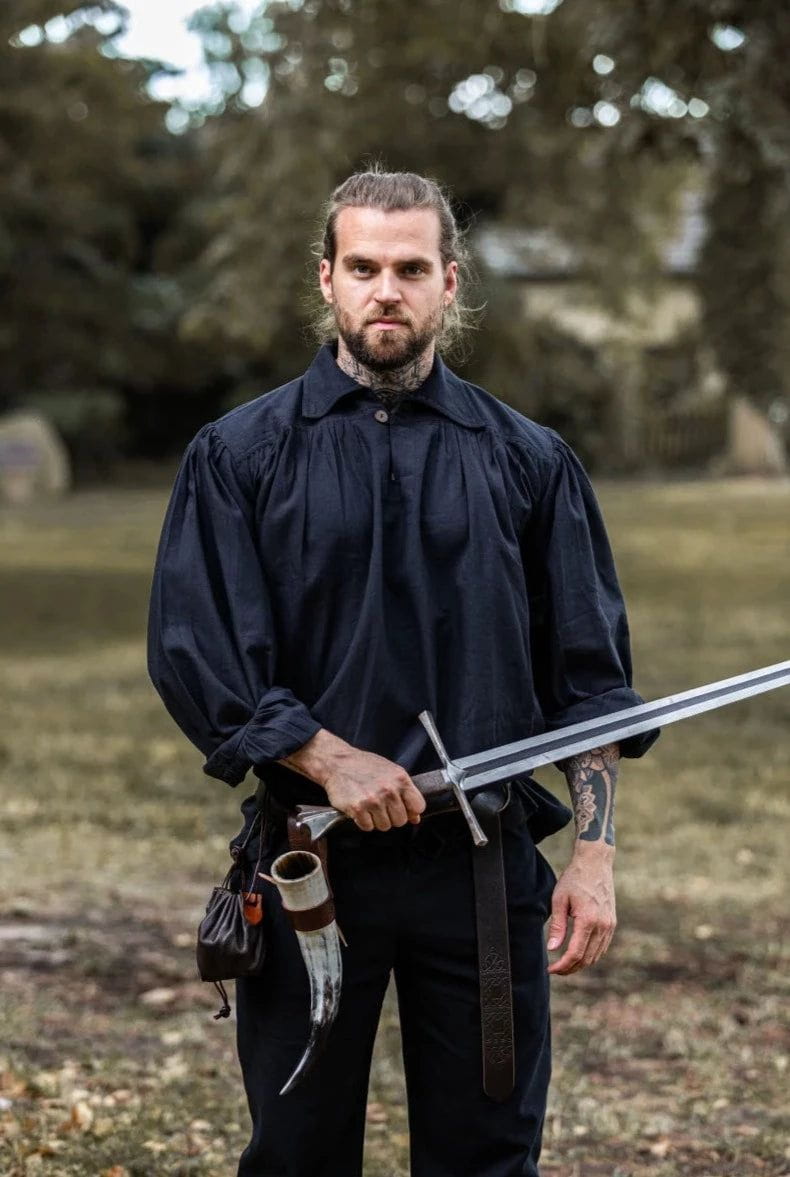 Man in black Pirate shirt with wooden buttons, holding a sword.