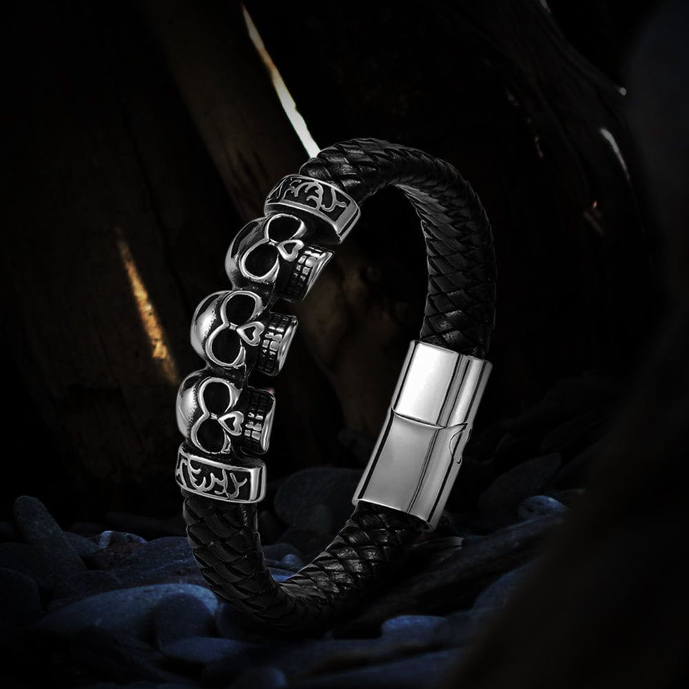 Black braided leather Pirate bracelet with three silver skull charms and a magnetic clasp.